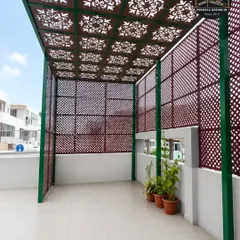 The interior view of the laser-cut pergola reveals how the patterned roof and walls create a beautiful play of light and shadow. This design provides a semi-enclosed feel while maintaining airflow and a connection to the outdoors.