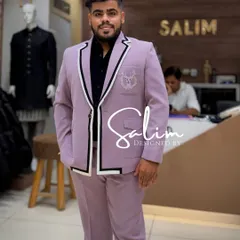 A client in a unique mauve-colored suit with bold black and white trim on the lapels. This is how I put a modern spin on a classic two-piece suit.