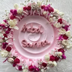 A top-down view of the tall floral cake, showing the intricate arrangement of tiny flowers and piped details.