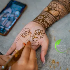 The process of creating a memory. Here you can see me sketching the couple's portrait directly onto the hand, using a photo on my phone as a reference to get every detail just right.