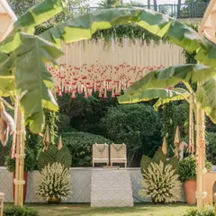 Embracing tradition and sustainability, this mandap uses locally sourced banana plants to create a natural, sacred arch. The backdrop of hanging rajnigandha and rose garlands adds a fragrant, classic touch to this intimate garden wedding ceremony.
