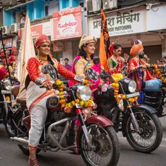 This shot captures the community aspect of the Gudi Padwa Shobha Yatra, showing a group of women riders smiling as they participate in the parade.