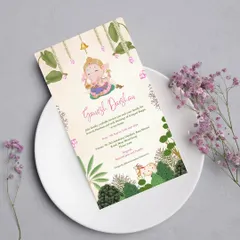 A soulful and artistic Ganesh Darshan invitation inspired by Pichwai art. The design features a charming illustration of little Ganesha amidst lush greenery, blending spirituality with traditional art.