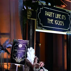 The entrance to the Great Gatsby party, featuring a custom-designed sign and art deco details. The first impression sets the stage for the entire themed experience.