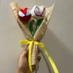For the superhero fan who has everything. This is a simple but striking bouquet of two tulips designed to look like Spider-Man's mask, wrapped in vintage-style newspaper print.