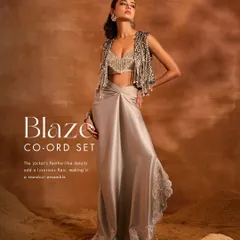 The Blaze Co-ord Set, featuring a jacket with luxurious feather-like tassel embellishments, a sequined blouse, and a flowing satin draped skirt. A true standout ensemble.