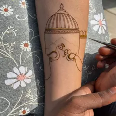 The beginning stages of an arm band design, showing the outline of two peacocks and a dome. This is the first step to creating a masterpiece.