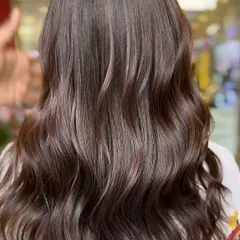 A beautiful balayage with soft, natural-looking highlights. This is a great example of a timeless hair color transformation that adds brightness and dimension.