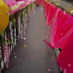 A decorated walkway on a balcony, showing how I use floral hangings and drapes to beautify every corner.