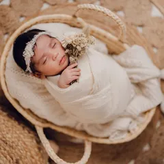 So tiny and perfect, sleeping peacefully in a rustic basket. The natural textures of the jute rug and woven basket create a warm, organic feel for this newborn portrait session.