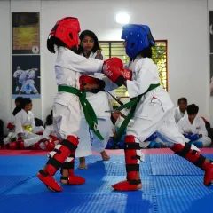 Two of our female students engage in a sparring match during a belt exam. They demonstrate excellent technique and control, showcasing the confidence and skill our program instills in all students.