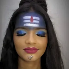 A Mahashivratri-inspired makeup look, featuring the iconic 'tripundra' on the forehead and a powerful blue smokey eye. These creative looks are a fantastic way for students to practice precision and artistry.