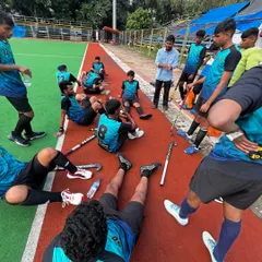 The team listens intently to the coach during a break in the action. These moments of guidance are crucial for making in-game adjustments and maintaining focus.