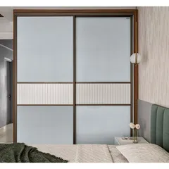 This custom-designed Aristo sliding door features a unique middle strip made from a laminated panel with linear grooves. This detail adds a layer of texture and sophistication to the wardrobe design.