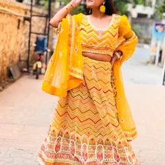 This yellow chevron-patterned lehenga is a top pick for Haldi functions. It's bright, fun, and photographs beautifully in the sunlight.