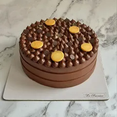 A simple yet elegant finish on my Decadent Belgian Chocolate Cake, topped with piped ganache and chocolate biscuits.