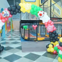 Goal! We created a fantastic football-themed birthday with a balloon arch, soccer ball details, and cutouts of famous players like Neymar.