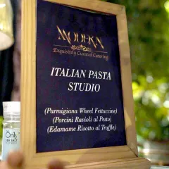 The menu for our Italian Pasta Studio, clearly listing the gourmet options available. We offer choices like Parmigiana Wheel Fettuccine and Porcini Ravioli to cater to sophisticated palates.