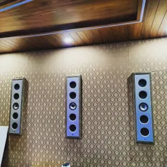 A closer look at the seamless integration of three KEF Ci5160RL-THX in-wall speakers. Mounted flush against a custom-finished wall, these speakers deliver powerful, reference-quality audio without compromising the room's interior design, demonstrating our philosophy of blending high performance with sophisticated aesthetics.
