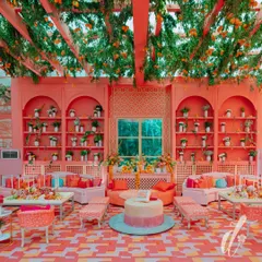 An overview of the lounge seating designed for a relaxed yet sophisticated atmosphere. The overhead citrus trellis and custom-built shelving filled with greenery and oranges create a cohesive and immersive environment.