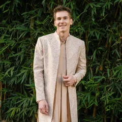This open sherwani paired with a Choga kurta is my modern take on the old Mughal era. It's handcrafted for a graceful silhouette, perfect for a wedding or a grand festive occasion. The look is timeless, elegant, and exceptionally comfortable.