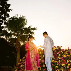A wide shot of their engagement, with the setting sun creating a beautiful flare. The palm tree adds a tropical, celebratory feel to this golden hour moment.