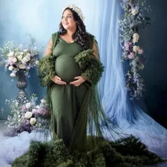 The same gorgeous green gown, this time set against a dreamy blue backdrop with floral arrangements. This shows how we can create different moods with the same outfit.