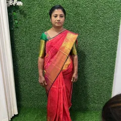 A full length view of the simple makeup look. The makeup is subtle and natural, ensuring the client looks and feels comfortable while beautifully complementing her traditional pink and green saree.