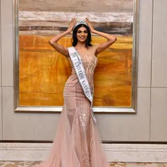 A moment of pure joy and achievement. The makeup is designed to look flawless from every angle, highlighting her features and creating a radiant glow that matches the crown.