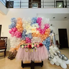 A wider view of the pastel balloon wall in a spacious home, showing how it can transform a living room into a spectacular party zone.
