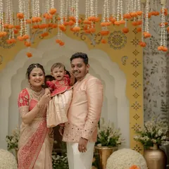 There is nothing more special than dressing the entire family. Here, we created a coordinated set in peach and red for a naming ceremony, ensuring the parents and their little one looked picture-perfect for their milestone celebration.
