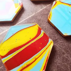 A close-up of one of the coasters, showing the bold stripes of red, yellow, and blue. The finishing touches are so important to make these pieces not just beautiful but also durable.