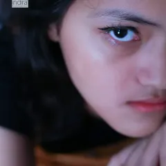 This is what I mean by capturing moods. This intense, close-up portrait from a teenage photoshoot reveals a story in her eyes. I create a comfortable space where teens can be themselves, allowing me to capture their true personality, whether it's quiet, bold, or somewhere in between.