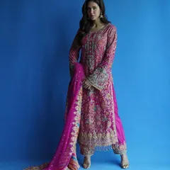 A full-length view of this magnificent Rimple and Harpreet suit. The way the heavily embroidered kameez and dupatta flow creates a truly royal silhouette, perfect for a wedding or major family function.