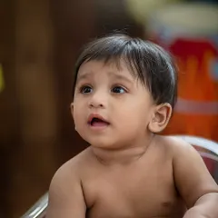 A simple, honest portrait. This close-up captures the beautiful details of this baby's face, from his curious eyes to his tiny features.