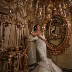 In this ivory gown, I explored the contrast between a corseted, fit-and-flare silhouette and the soft power of a dramatic hooded panel. The hand embellishments are meticulously placed to catch the light, creating a piece that feels both intentional and unforgettable, perfect for a modern bride.