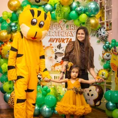 A friendly tiger mascot joins the birthday girl for a photo at her jungle-themed party. Mascot visits add an extra layer of magic to the celebration.