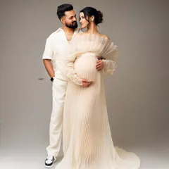 A classic portrait of the happy couple. Their matching smiles and the way they look at each other says it all. The pleated white gown adds a touch of elegance.