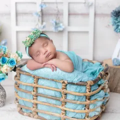 The peaceful sleep of a newborn is pure magic. I use soft wraps and cozy props like this basket to create classic, artistic portraits of your baby in their first few days.