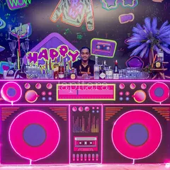 A custom-built bar designed to look like a giant neon boombox. This creative and functional piece was the centerpiece of the beverage station at a retro-themed neon party.
