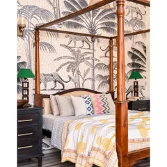 A four-poster bed is a timeless classic. In this master bedroom, we paired it with a dramatic black and white jungle-themed wallpaper and dangling bamboo lamps to fill the 20-foot high ceiling space.