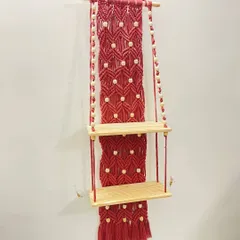 For those who need a bit more storage, I created this two-tier macrame shelf in a striking red. The design includes a detailed macrame back panel with wooden bead accents, adding both function and a vibrant decorative element to your wall.