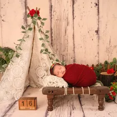 For the adventurous family, this little camper theme with a lace teepee, rustic wood, and pops of red is a wonderfully unique and charming choice.