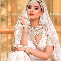 For the bride who loves elegance and grace, this all-white lehenga with intricate pearl and thread work is a dream. The matching jewellery set completes a look that is both modern and ethereal, perfect for a day wedding or reception.
