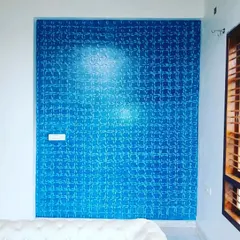 A geometric pattern applied to a blue accent wall. This textured finish catches the light differently throughout the day, adding subtle complexity to the room.
