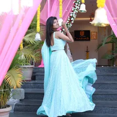 This is the same beautiful shot from the designer studio apparel shoot, highlighting the flowing fabric and intricate details of the light blue lehenga.