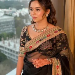 This client is the picture of timeless luxury in a classic black Sabyasachi saree. I created a soft glam look with dewy, glowing skin and gentle waves in her hair to complement the intricate floral embroidery of her outfit, perfect for an elegant evening affair.