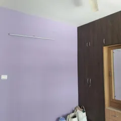 A soothing lavender-colored wall in a bedroom. This simple yet elegant color choice creates a calm and relaxing environment.