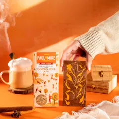 A styled shot for a Pumpkin Spice Latte chocolate bar. The warm, orange tones and cozy props evoke an autumnal feeling.