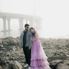 A moody, atmospheric portrait on a rocky shore with the Bandra-Worli Sea Link in the background. This shows how I can blend natural and urban elements.